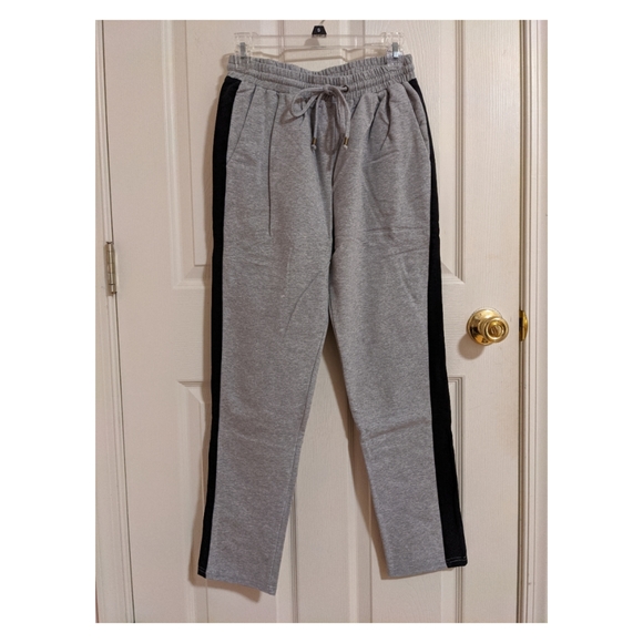grey joggers with black stripe
